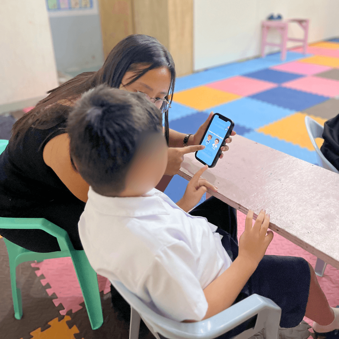 A child using the TabTap AAC picture board to communicate